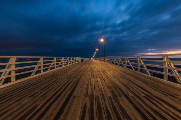 istock Editorial only: Shorncliffe pier with street lamp lights 1179271801