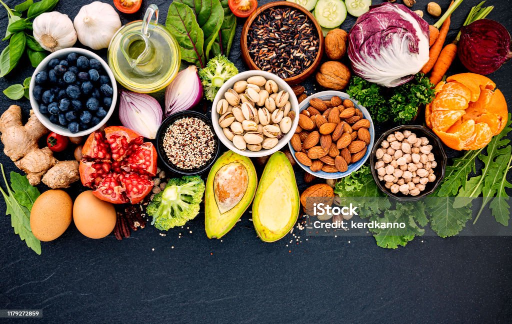 Ingredients for the healthy foods selection. The concept of healthy food set up on dark stone background. Healthy Eating Stock Photo