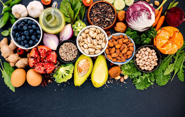 Ingredients for the healthy foods selection. The concept of healthy food set up on dark stone background. Ingredients for the healthy foods selection. The concept of healthy food set up on dark stone background. carotene stock pictures, royalty-free photos & images