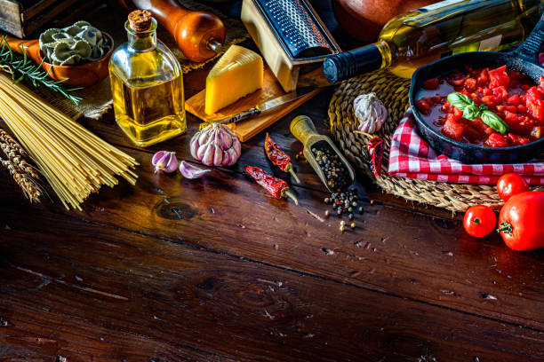 istock Italian pasta and ingredients on rustic pots and wooden table in a kitchen 1179274128