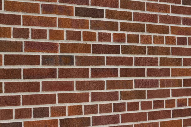 istock Traditional dark brown vintage brick wall texture background (angle view) 1179275864
