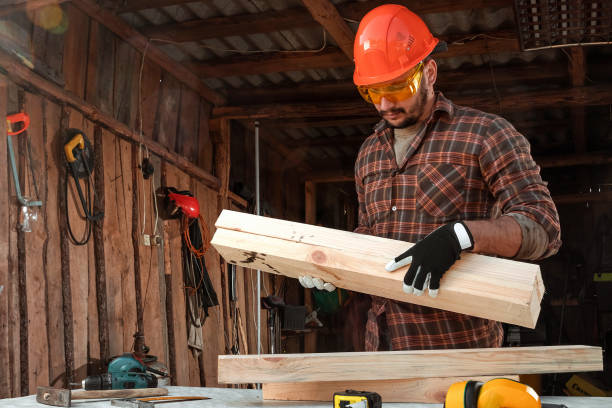 istock Builder man carries boards on his shoulder. Construction work, repair. 1179289445