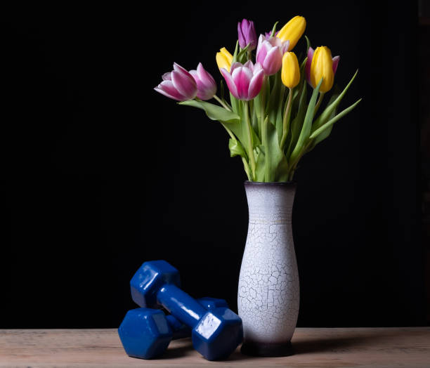 istock flowers and dumbbells on the table background dark 1179296455
