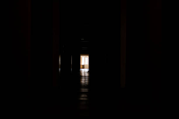 istock the dark corridor at the end of which bright window 1179297113