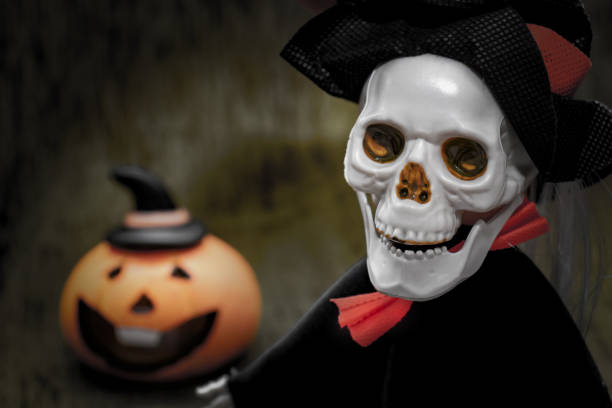 istock Halloween card with spooky skeleton and orange pumpkin on dark background 1179300202