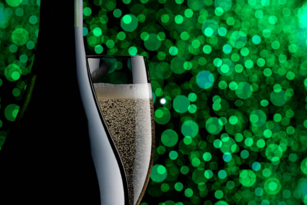 istock Champagne glass and blank bottle against defocused illumination 1179301180