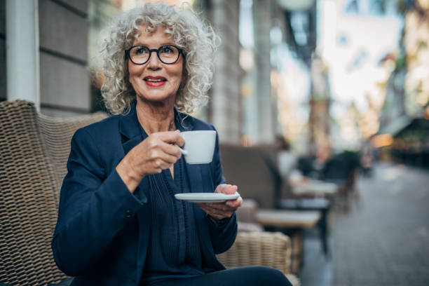 istock Beautiful senior woman drinking a hot drink 1179301968