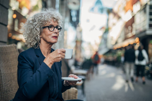 istock Beautiful senior woman drinking a hot drink 1179301982