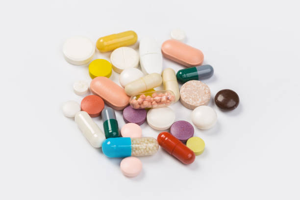 istock Assorted pharmaceutical medicine pills, tablets and capsules.Heap of assorted various medicine tablets and pills different colors on white background. 1179302102