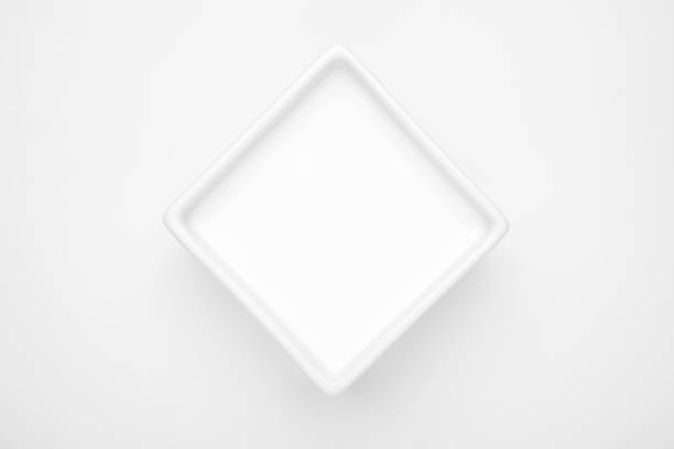 istock Milk in a square porcelain bowl on white background 1179302124