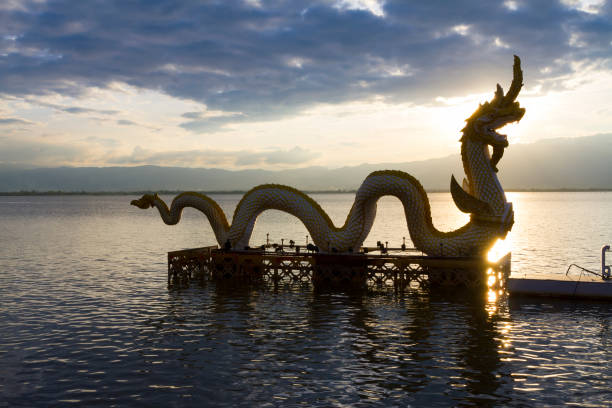 istock Sunset and sunlight with statue dragon on Kwan Phayao 1179303145