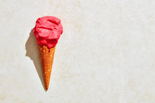 istock Fresh strawberry ice cream in waffle cone with hot summer light 1179303888
