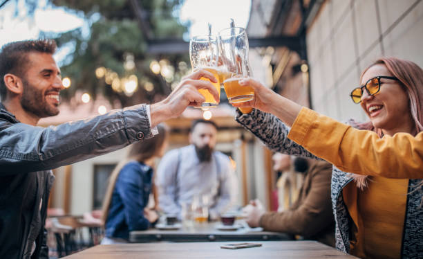 istock Group of young joyful friends having fun in a pub 1179304168