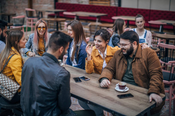 istock Group of young joyful friends having fun in a pub 1179304301