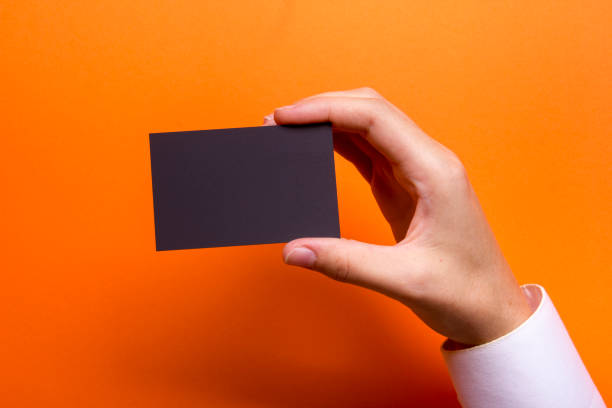 istock Hand holding white business card on white background 1179305099