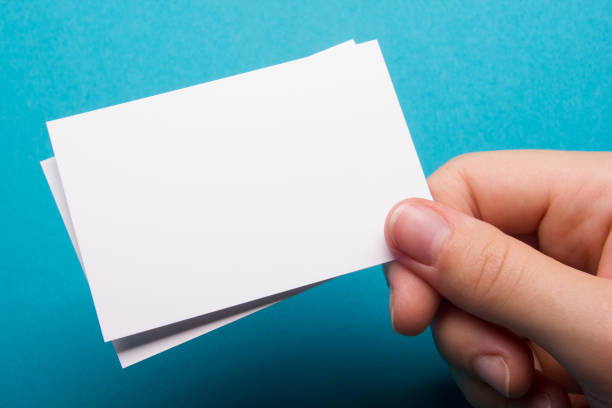 istock Hand holding white business card on white background 1179305166