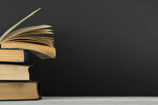 istock Open book, hardback books on wooden table. Back to school. Copy space 1179306074