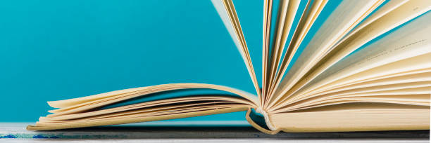 istock Open book, hardback books on wooden table. Back to school. Copy space 1179306339