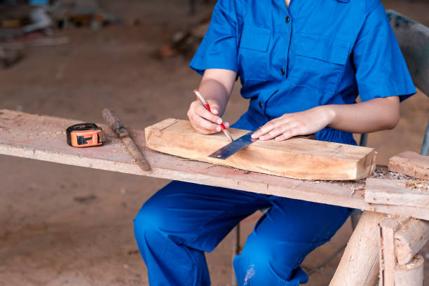 istock Technician girl hands use pencil to work with wood during day time 1179306343