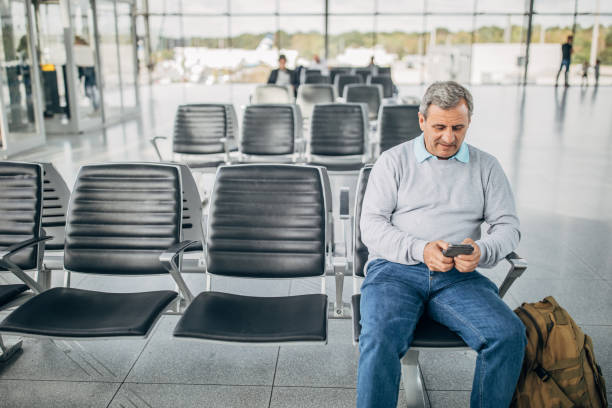 istock Businessman at airport using phone 1179307248