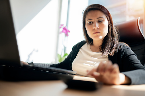 Businesswoman using calculator