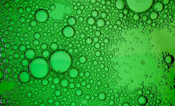 istock Oil drops on a water surface - Water bubbles abstract light illumination 1179311433