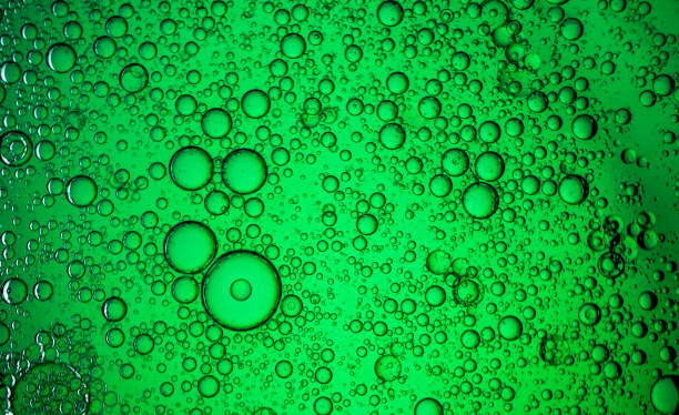 istock Oil drops on a water surface - Water bubbles abstract light illumination 1179311843