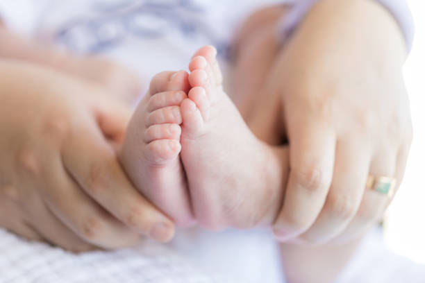 istock Feet for newborns in mother's hands 1179316131