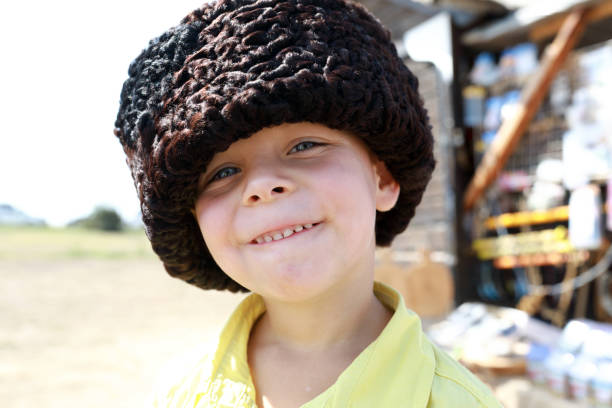 Portrait of child in Russian Karakul Kubanka Cossack Hat