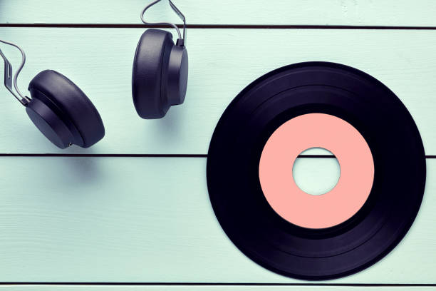 istock Vinyl record and a headphone on blue wooden background 1179319781