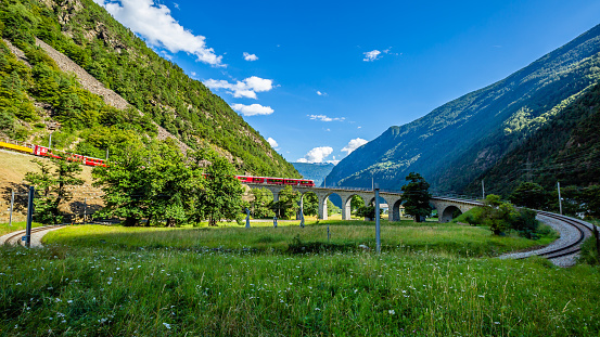 Brusio,Switzerland , august 11 2016: Bernina express- train on the circular viaduct bridge near Brusio on the Swiss Alps