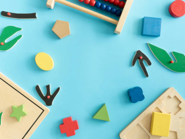 istock kids learning concept with stacking toys on blue table background. 1179321233