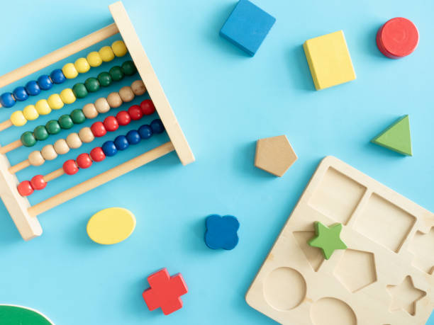 istock kids learning concept with stacking toys on blue table background. 1179321234
