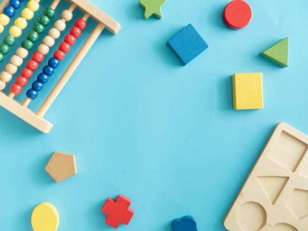 istock kids learning concept with stacking toys on blue table background. 1179321262