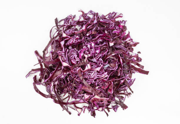 Sliced red cabbage on white Heap of sliced red cabbage on white background - view from above red cabbage stock pictures, royalty-free photos & images