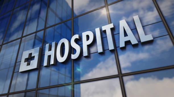 Hospital building with glass wall and mirrored building Hospital glass building. Mirrored sky and city on modern facade. Health, clinic, emergency, healthcare and medical concept in 3D rendering illustration. european hospital sign stock pictures, royalty-free photos & images