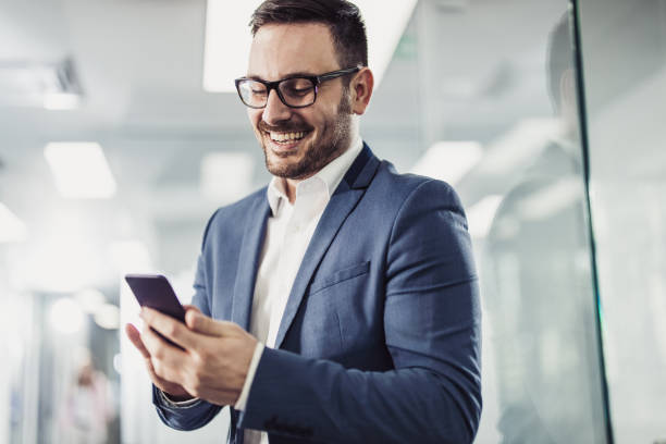 istock Young happy businessman text messaging on cell phone. 1179325762