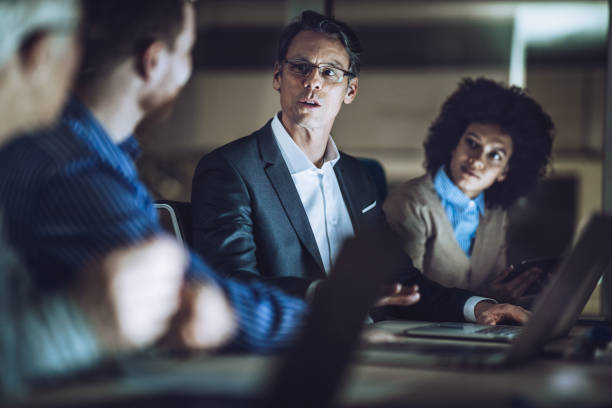 istock Business colleagues talking while working late in the office. 1179326217