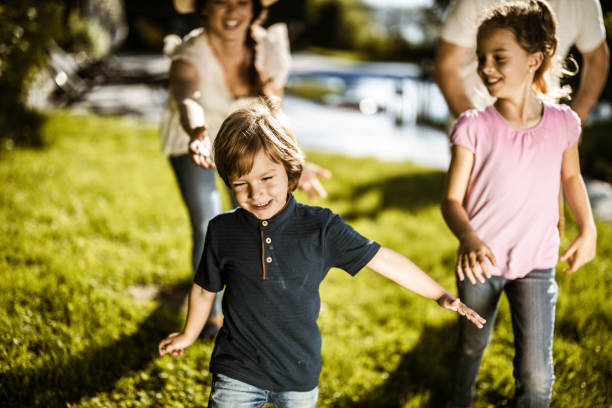 istock Carefree kids having fun while running away from their parents in the backyard. 1179329183