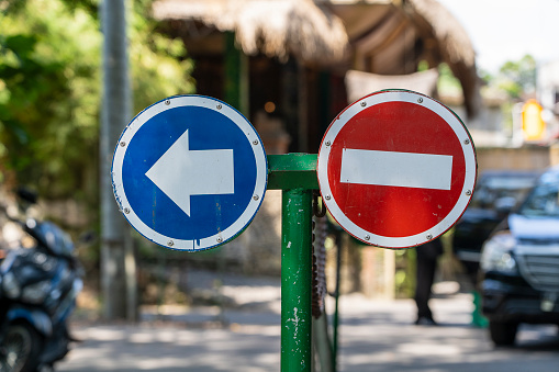 No entry and turn left sign on the street in island Bali, Indonesia, close up
