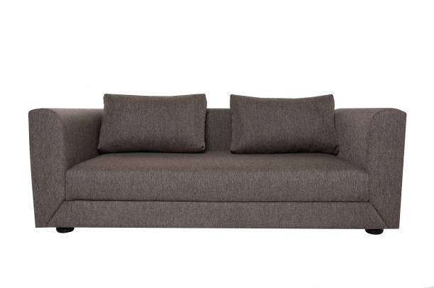 istock Modern grey fabric sofa with pillows isolated on white background. Strict style furniture 1179334330