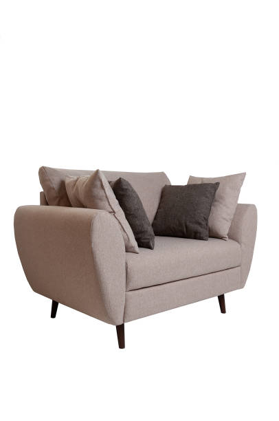 istock Modern small grey fabric sofa with pillows isolated on white background. Strict style furniture 1179334348