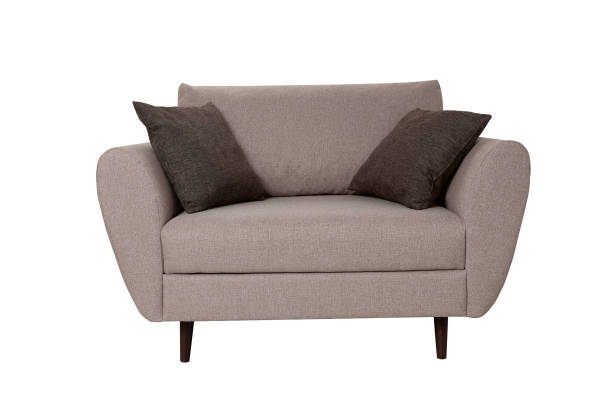 istock Modern small grey fabric sofa with pillows isolated on white background. Strict style furniture 1179334364