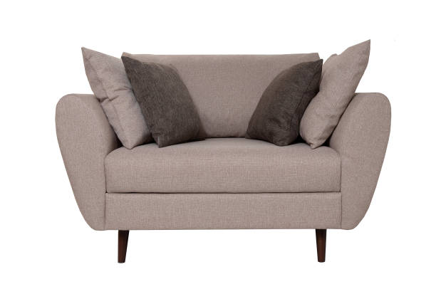 istock Modern small grey fabric sofa with pillows isolated on white background. Strict style furniture 1179334380
