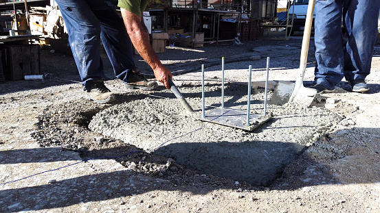 pouring cement on a construction site image