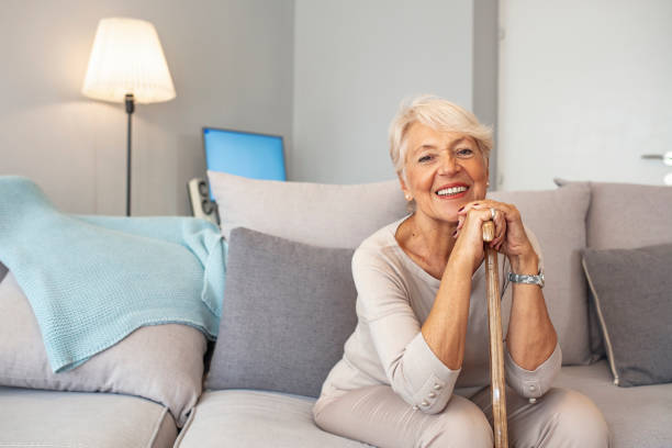 istock Old woman sitting with her hands on a cane 1179336564