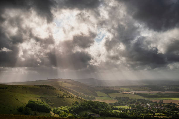 istock Stunning Summer landscape image of escarpment with dramatic storm clouds and sun beams streaming down 1179343208