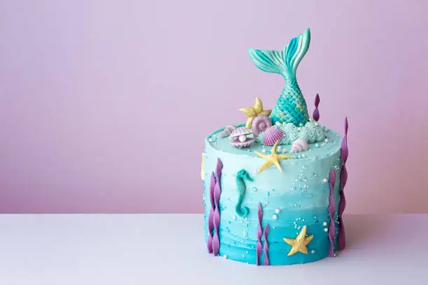 Mermaid birthday cake on a purple background