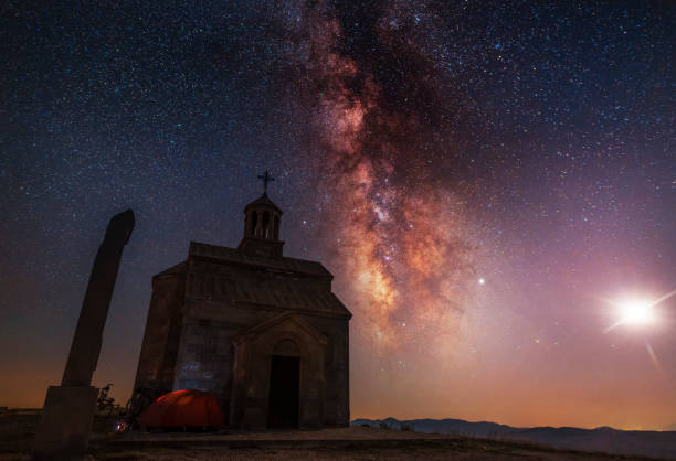 istock Beautiful night landscape. A small chapel on the hill. Behind the chapel, is a bright milky way galaxy. 1179347340
