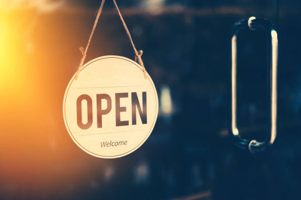 istock Open sign hanging front of cafe with colorful bokeh light abstract background. 1179347816